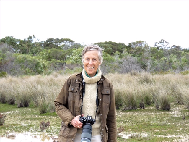 Photo of Robin Spry in the field with her camera.